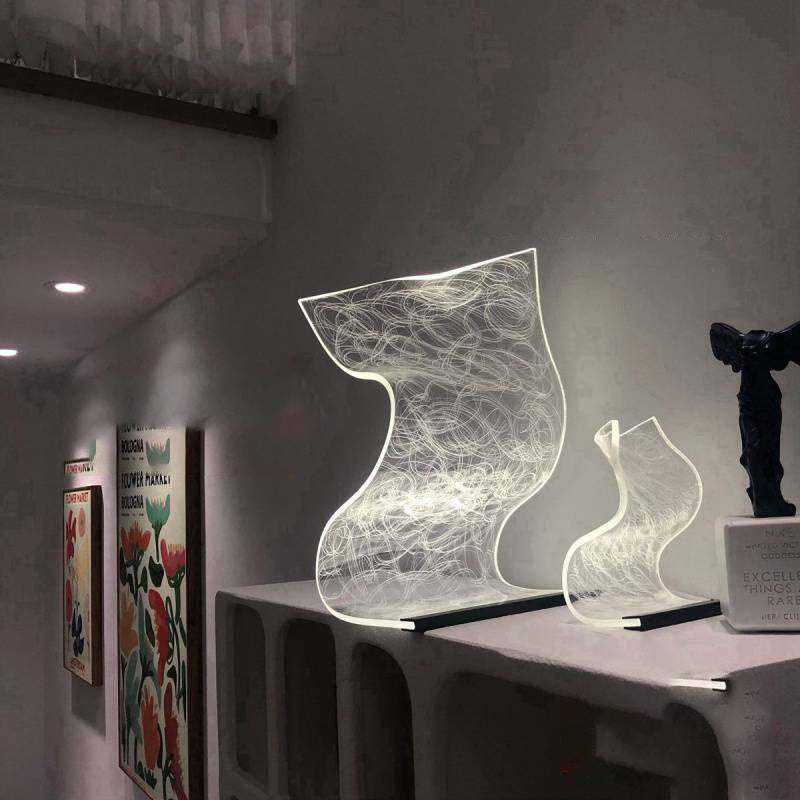 modern warm high appearance level bedside lamp with abstract light design on table