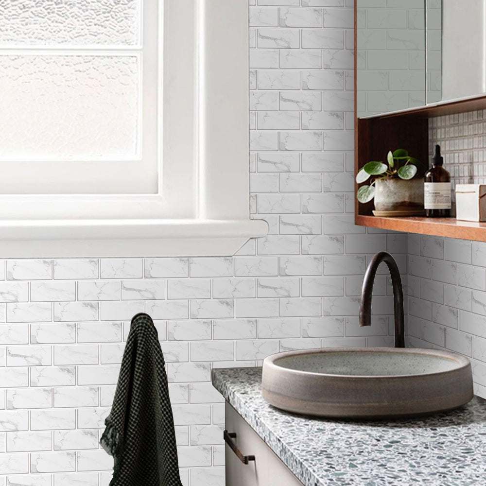 White marble look peel and stick tile stickers on bathroom wall next to sink and mirror