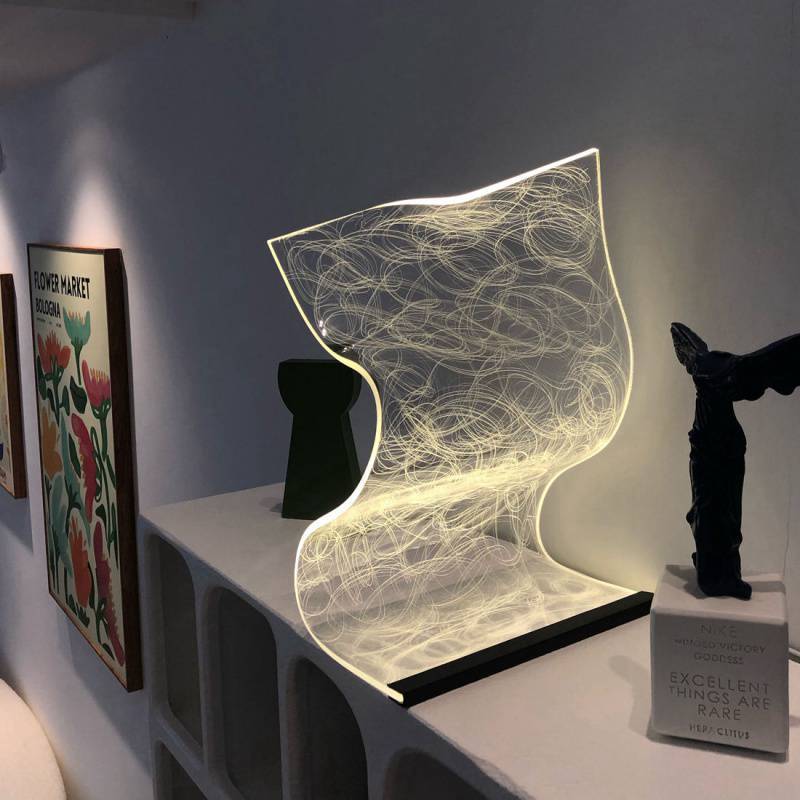 Nordic style warm high appearance level bedside lamp with abstract light pattern and USB switch cable on white shelf