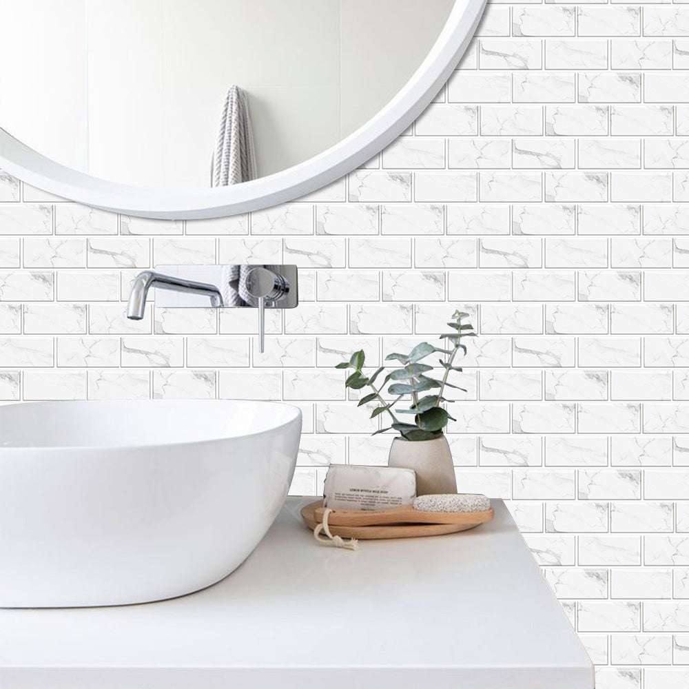 White marble look peel and stick tile stickers on bathroom wall with white sink and round mirror