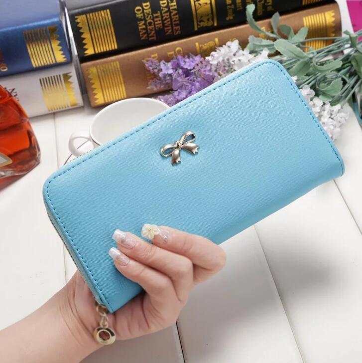 Ladies wallet handbag in sky blue PU with zipper and bow detail