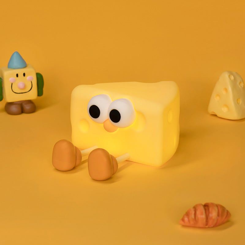 Cheese-shaped small silicone night lamp with cute eyes and legs on yellow background