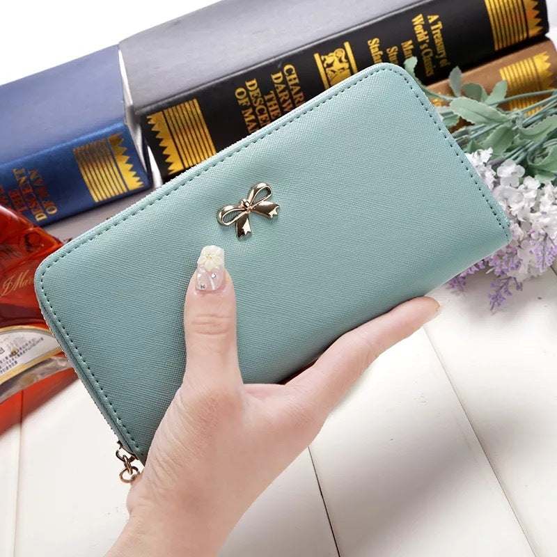 Ladies wallet handbag in light blue PU with zipper and bow detail, size 19x9.5x3cm