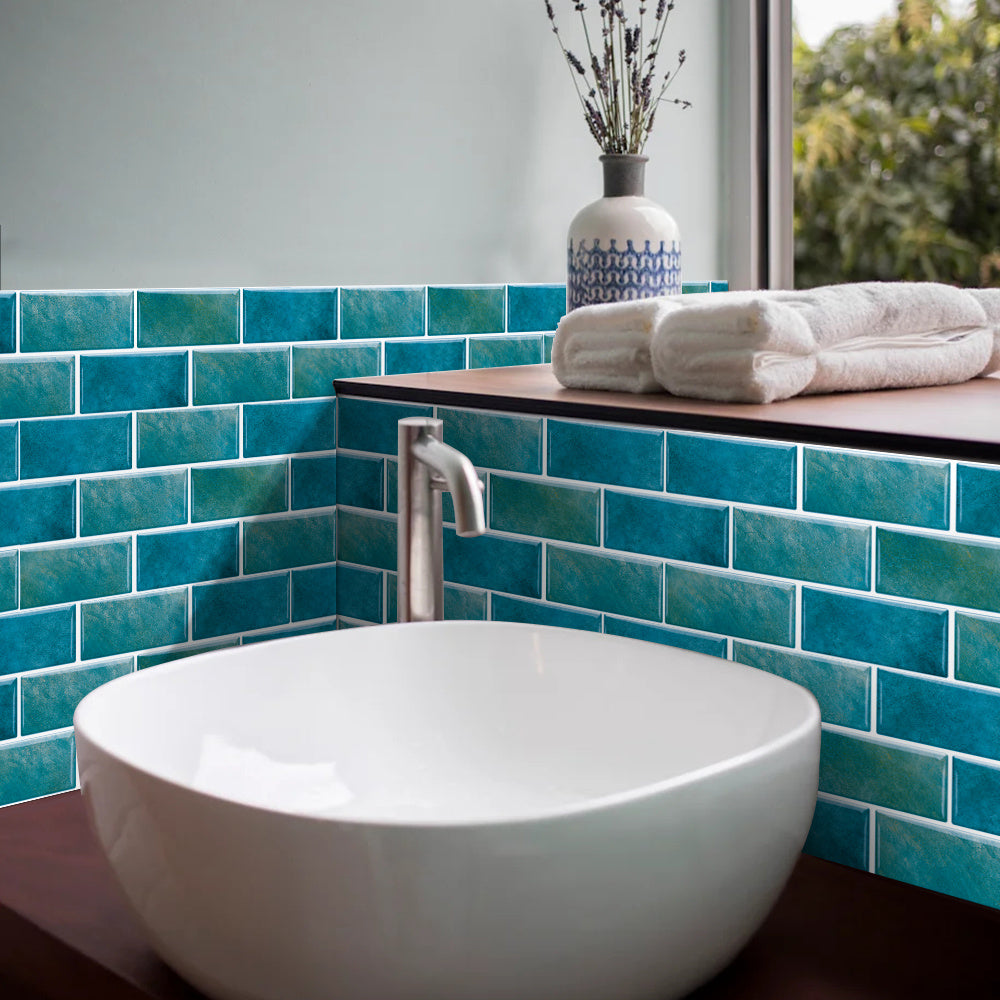 Blue green marble tile wall stickers in bathroom with white sink and folded towels