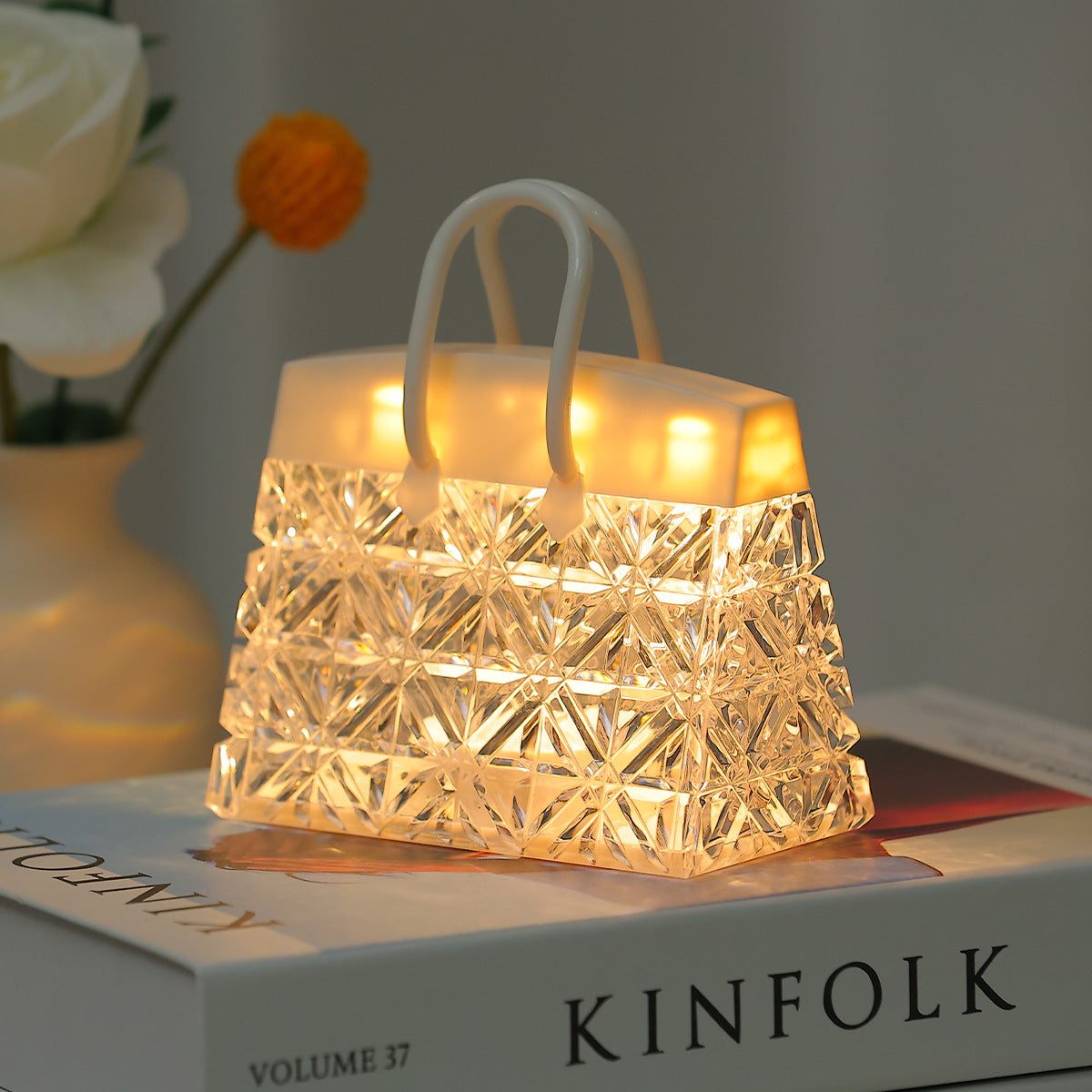 Acrylic warm light small night lamp shaped like a geometric handbag with built-in battery and transparent crystal design