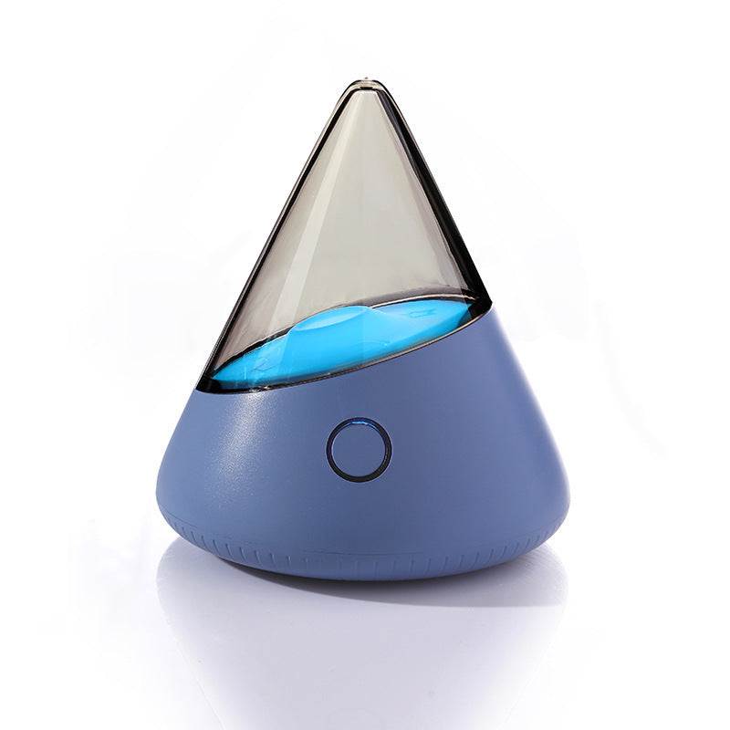 Colorful small night lamp with geometric design and blue light on white background