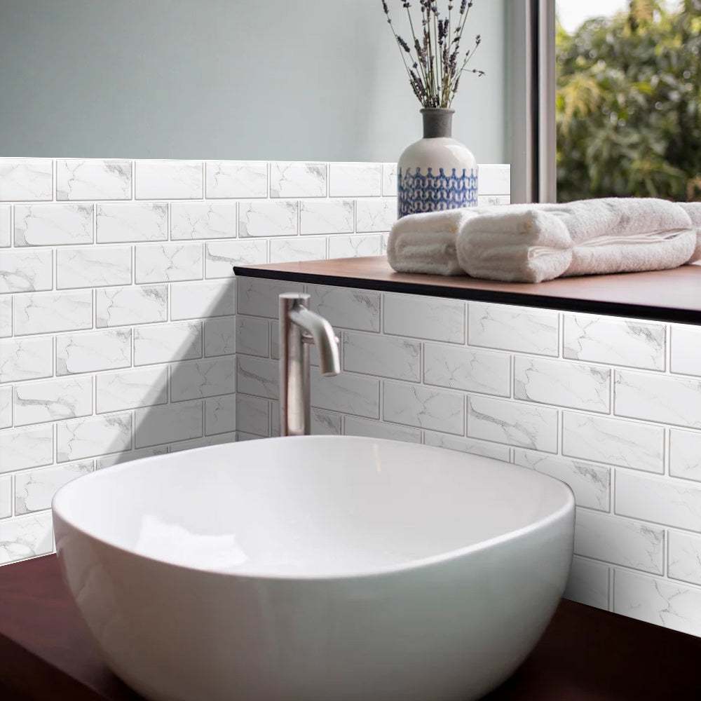 white marble look peel and stick tiles backsplash in bathroom with white vessel sink and wooden countertop