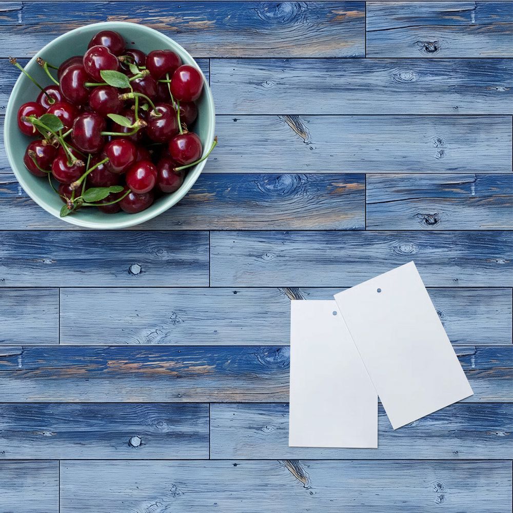 blue wood grain peel and stick floor tiles with cherries in bowl and two blank cards on top