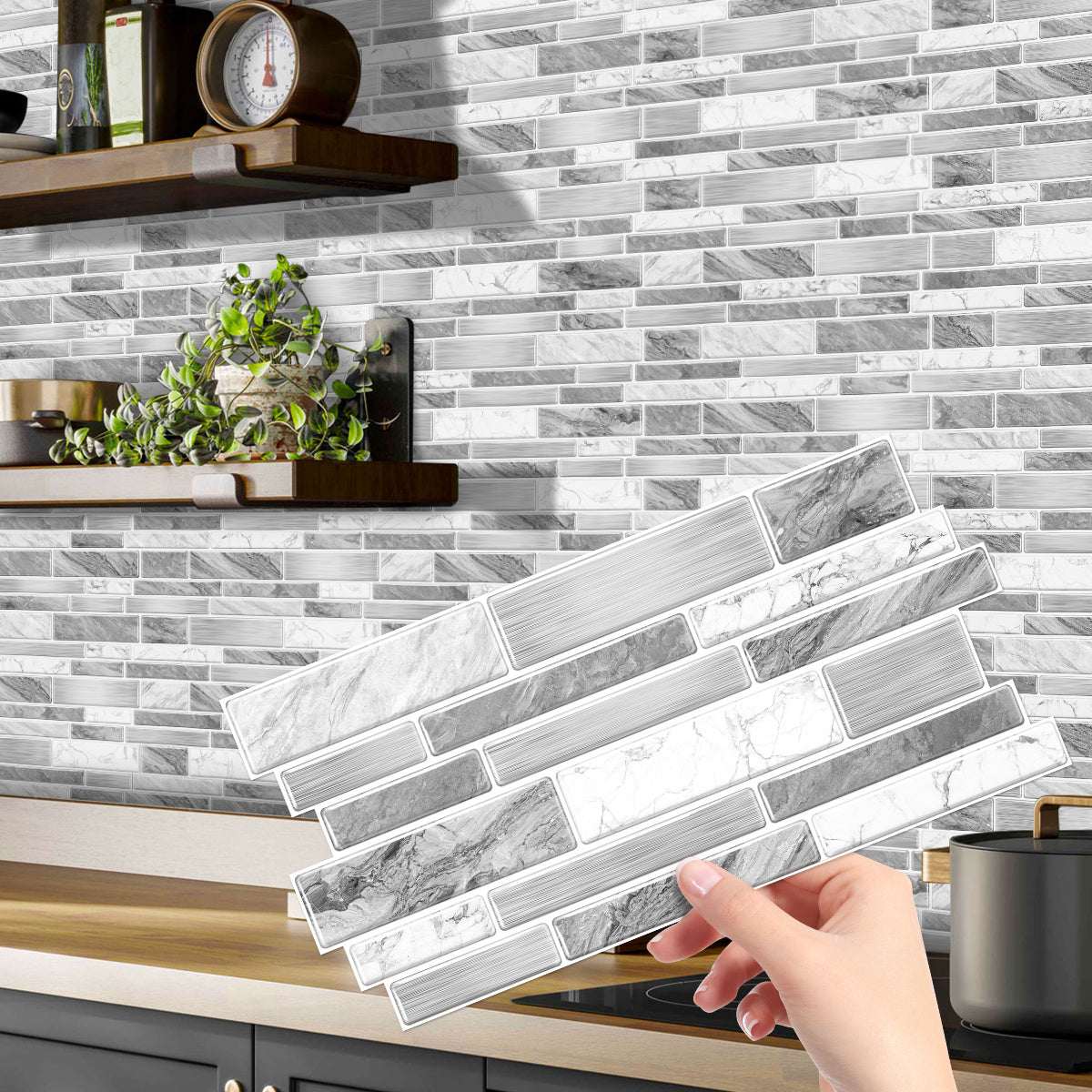 Hand holding irregular shape modern grey marble pattern peel and stick kitchen backsplash tile sticker with kitchen background