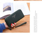 Casual single pull ladies wallet in lychee pattern PU leather with zipper and wrist strap on wooden table
