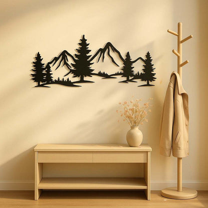 Rustic metallic wall art featuring evergreen forest and mountain design in black silhouette above wooden bench in minimalist room