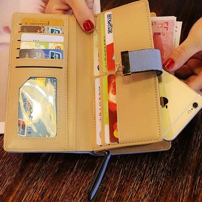 Beige women's wallet purse with multiple card slots, zipper pocket, and phone compartment on wooden table