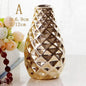 Nordic ceramic small flower vase with a shiny textured gold finish and geometric pattern, 12cm tall.