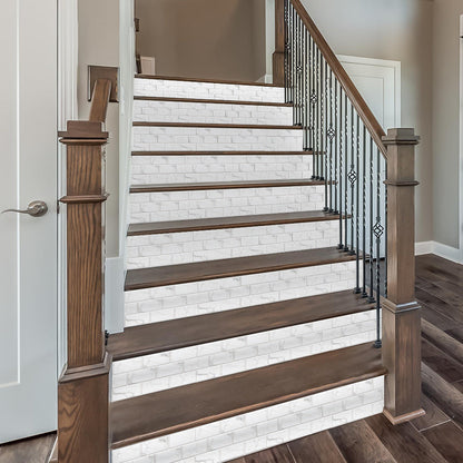 white marble look peel and stick tile stickers on stair risers with wood steps and black iron railing