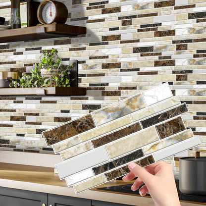 Hand holding classic imitation porcelain tile peel and stick backsplash with marble design in kitchen setting