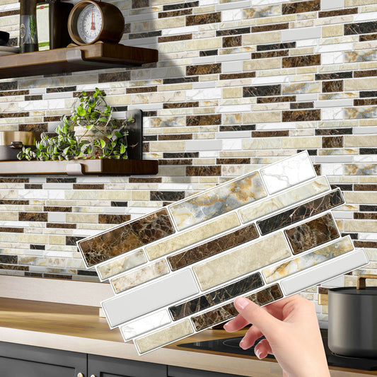 Hand holding classic imitation porcelain tile peel and stick backsplash with marble design in kitchen setting
