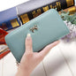 Ladies wallet handbag in light blue PU with zipper and bow detail, size 19x9.5x3cm