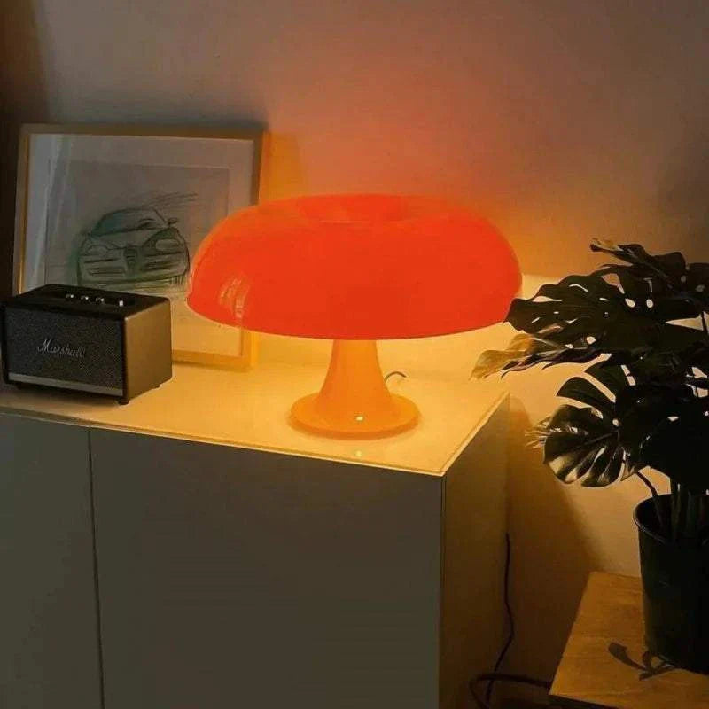 Orange mushroom-shaped table lamp with warm LED glow on modern cabinet