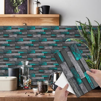 Modern green marble stone tile peel and stick wallpaper on kitchen wall with hand holding tile sticker