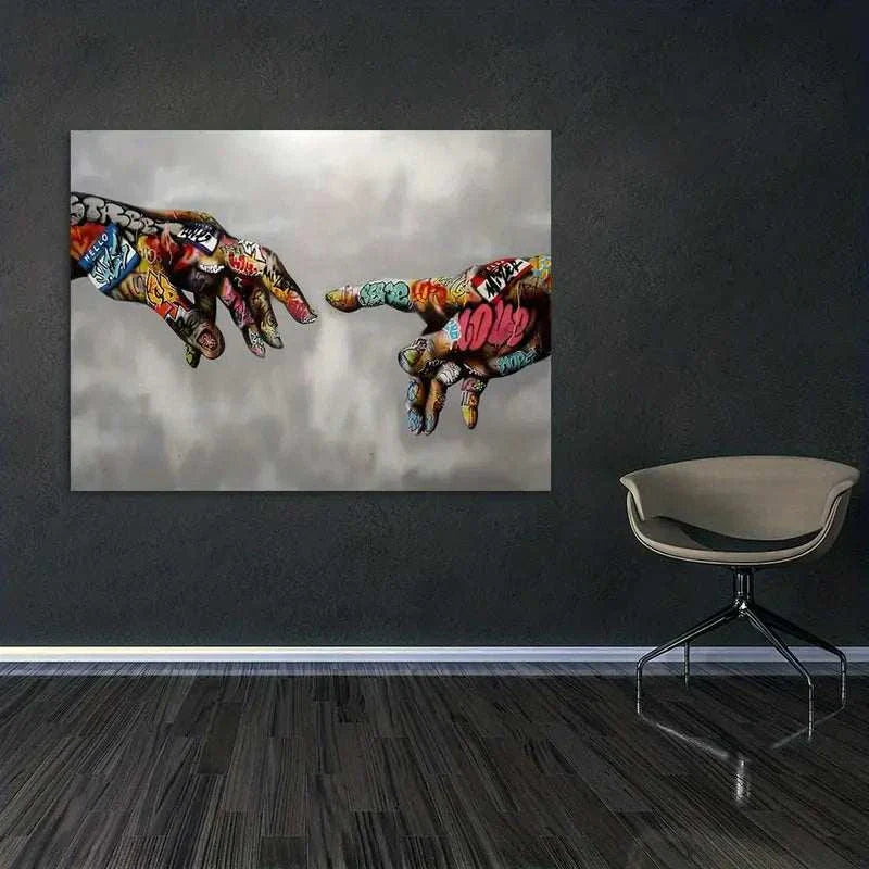 Canvas graffiti wall art featuring colorful spray-painted hands reaching towards each other on a gray background in a modern room setting